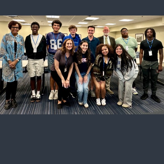   Group of students standing in front of a welcome screen